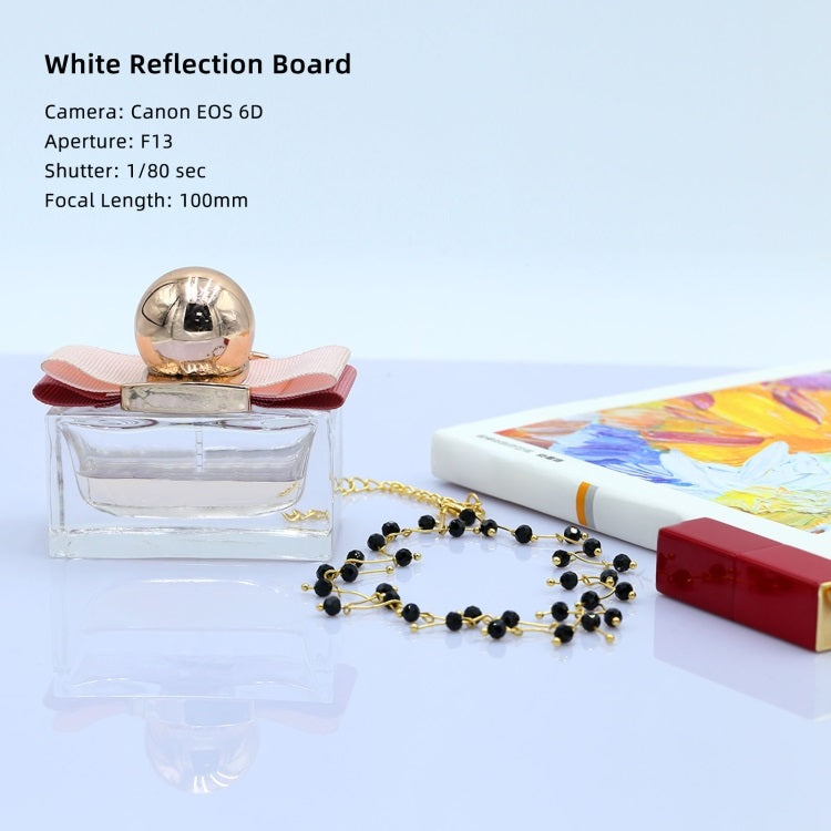 Acrylic Reflective Display Board showcasing fashion accessories and a perfume bottle for photography setups