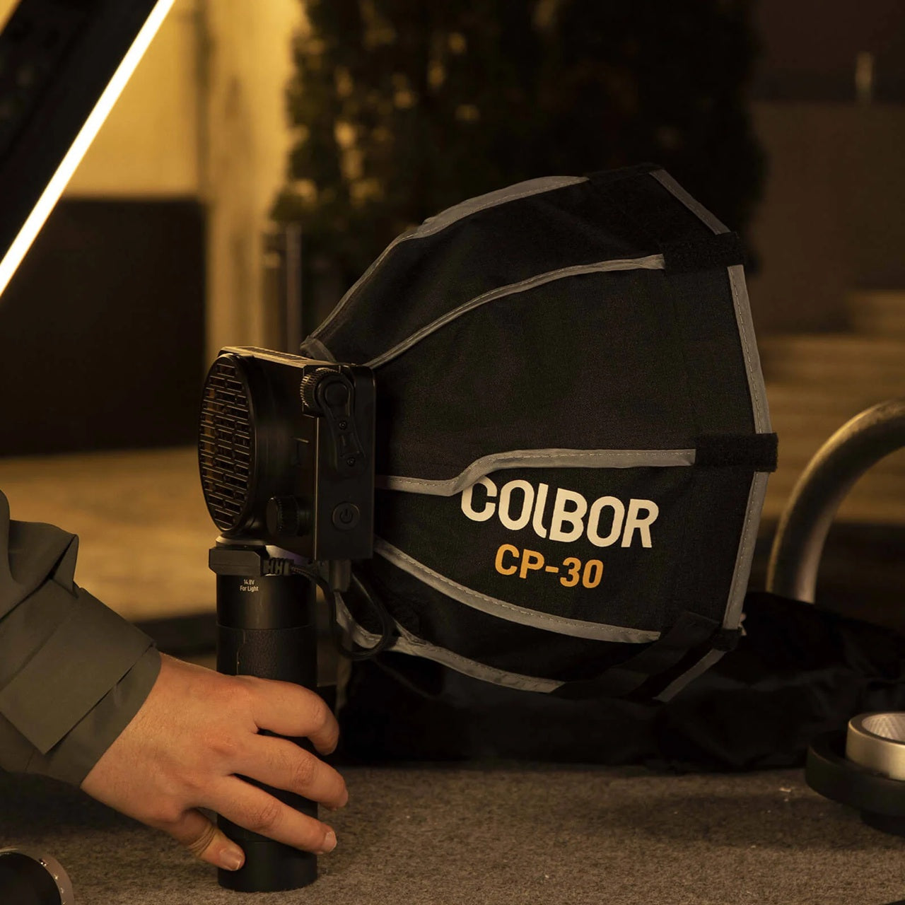 Portable rechargeable battery for LED lights with Colbor CP-30 softbox attached