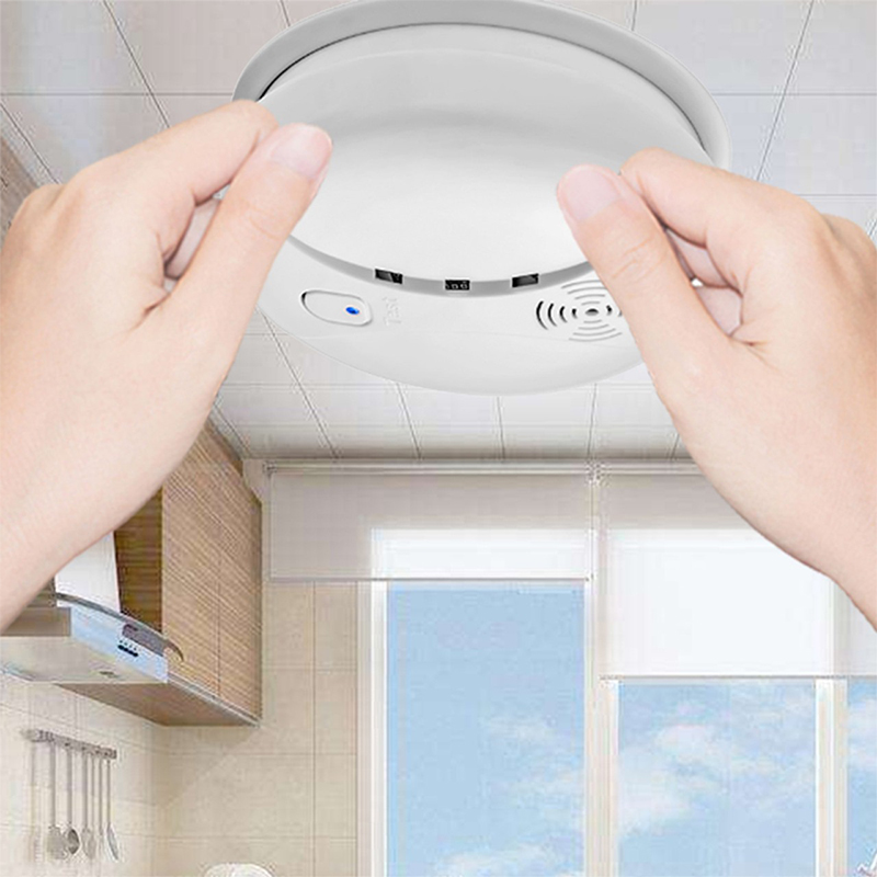 Hands installing DAYTECH SM02 and SM08 Smoke Alarm on kitchen ceiling for home security