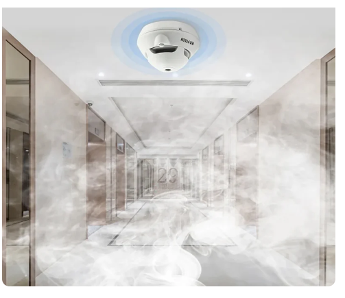 DAYTECH SM06TA smoke detector mounted on ceiling detecting smoke in a residential hallway