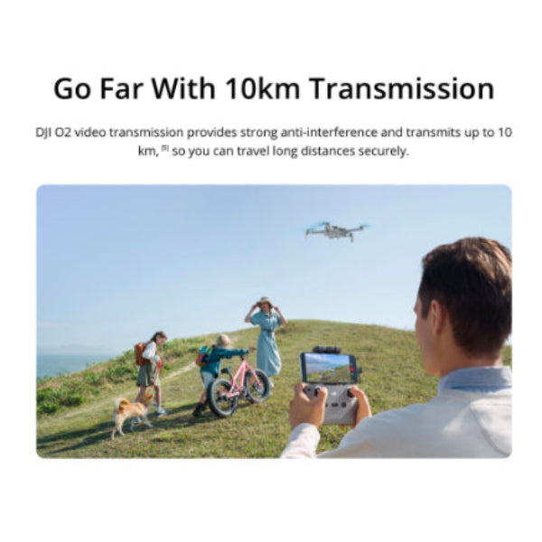 Person flying DJI Mini 3 drone with 4K camera using remote controller outdoors over a hill