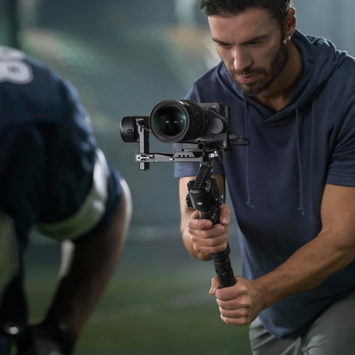 Man using DJI RS 4 gimbal stabilizer by VMIDirect to capture smooth video with a professional camera