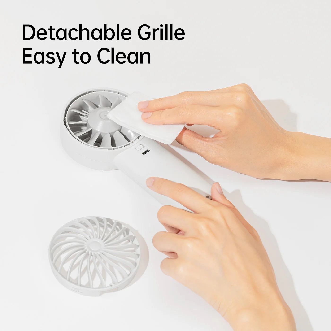 Jisulife life 4 strong wind fan handheld fan with detachable grille being cleaned by hand