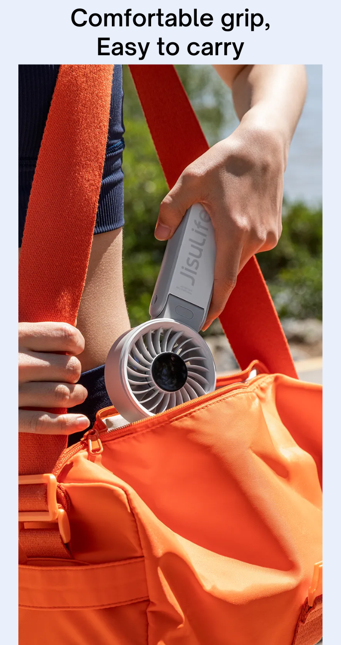 Jisulife mini fan portable handheld fan with comfortable grip being placed in an orange bag
