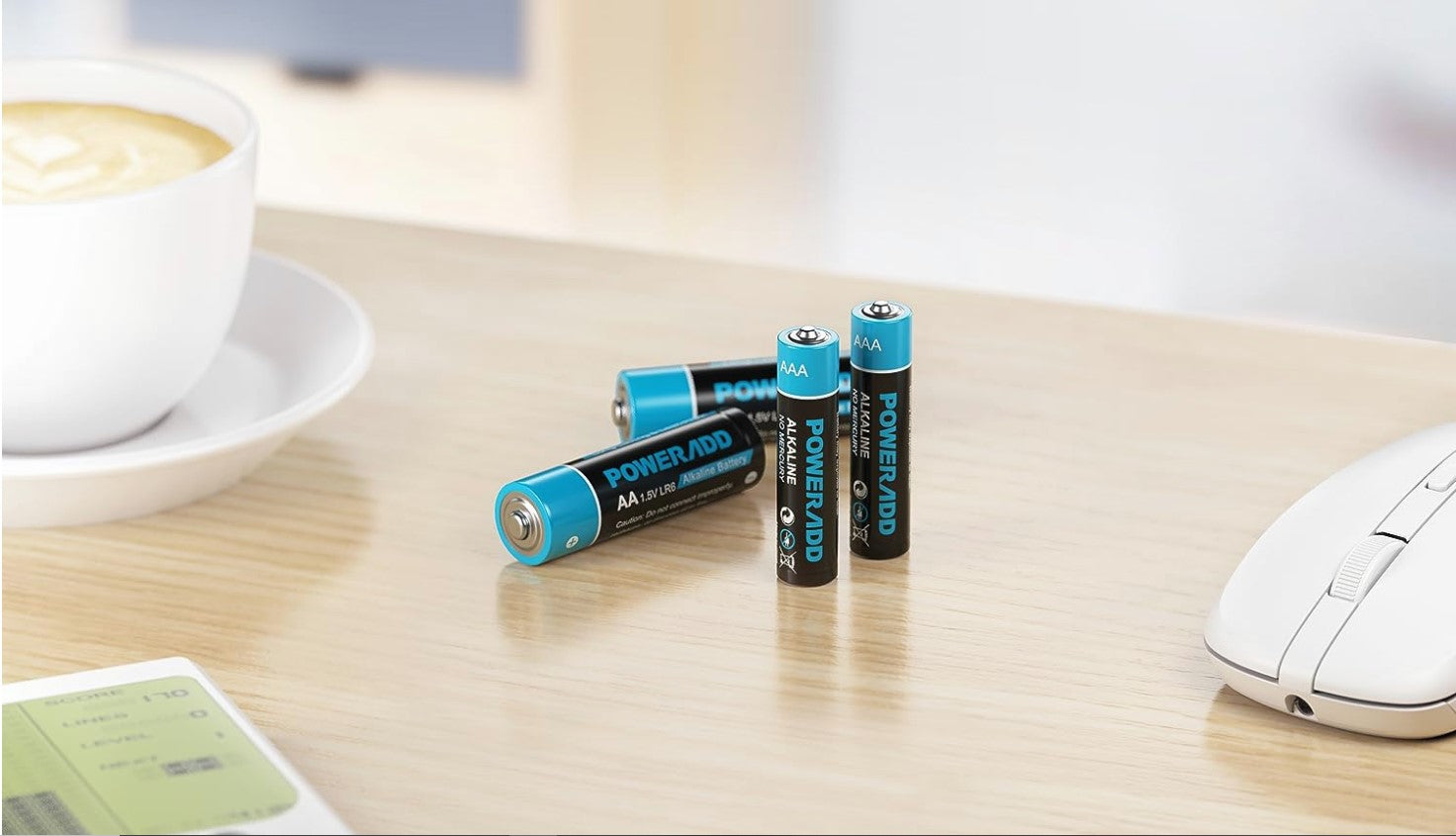 VMIDirect AA Battery 1.5v Non-Rechargeable Alkaline Batteries on a desk next to a coffee cup and mouse