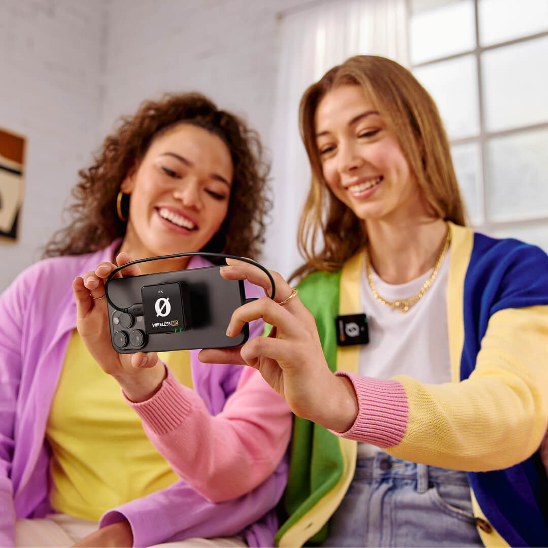 Rode Wireless ME Microphone System used by two women showcasing smartphone connectivity and clear audio features