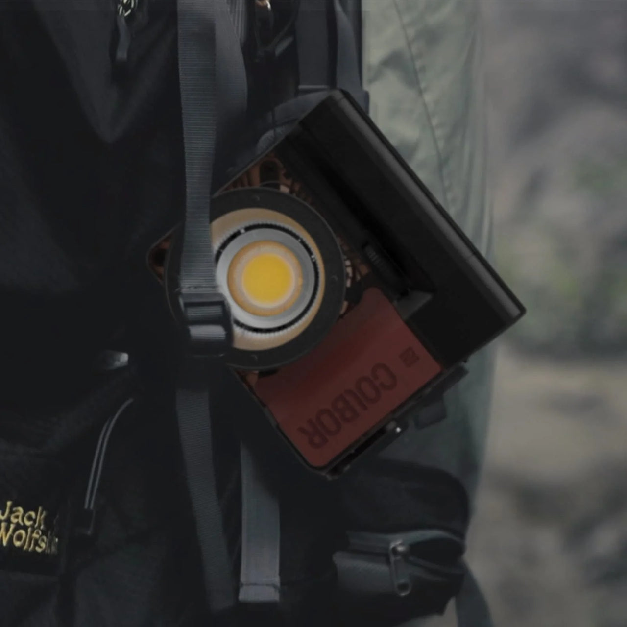 Synco Colbor PB74 battery base attached to a backpack for on-the-go photography convenience
