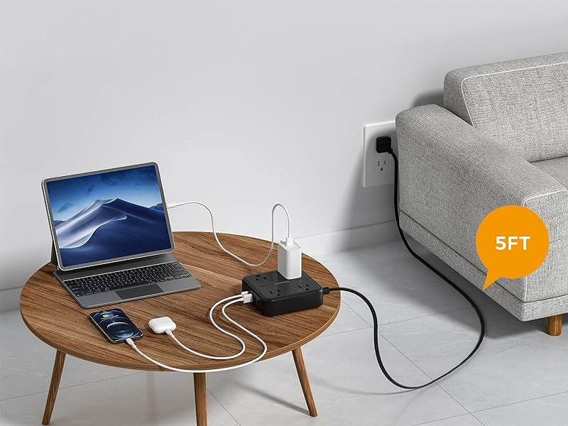 5FT flat plug power strip extension cord powering laptop and devices on wooden table