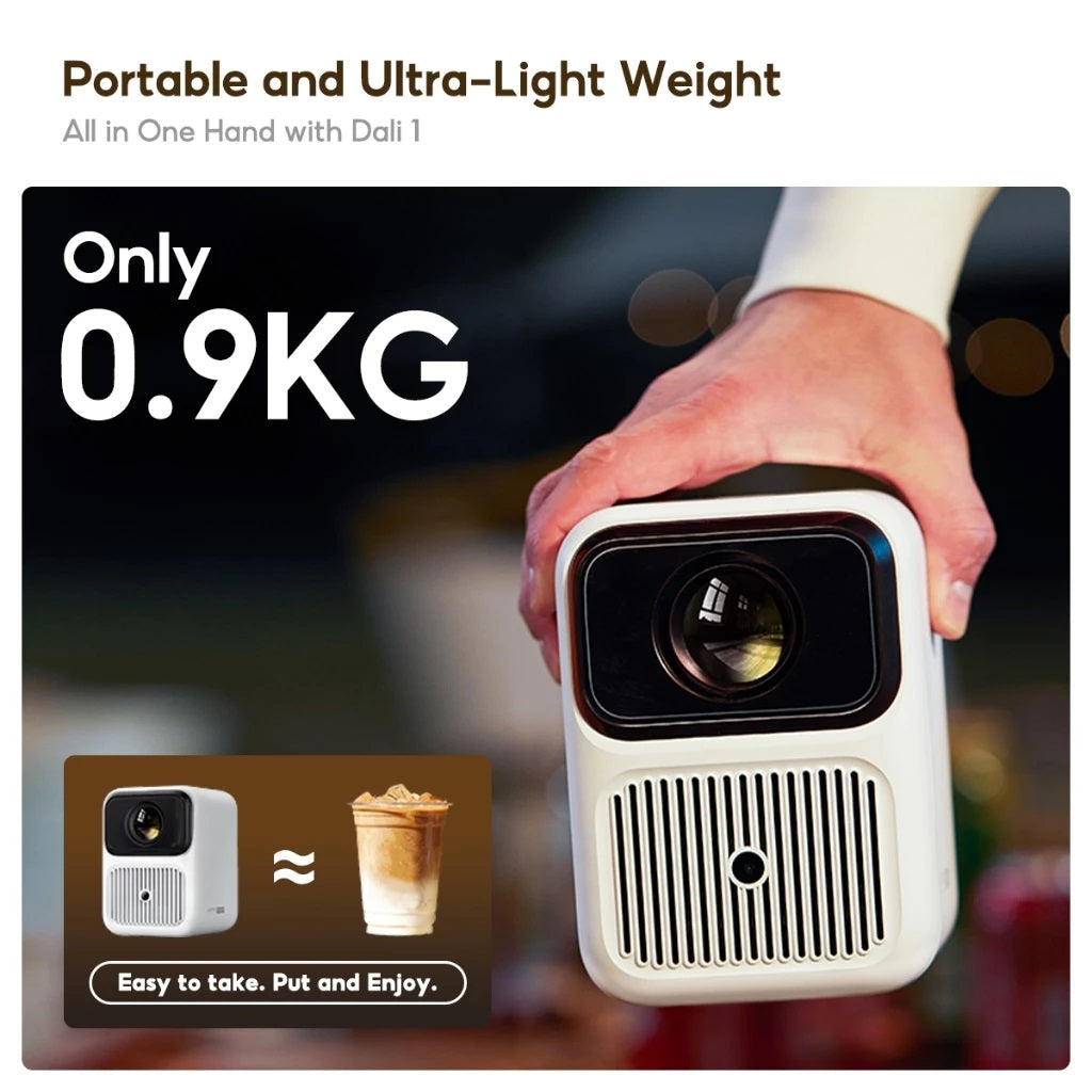 Hand holding Wanbo Dali 1 portable projector showing its compact and lightweight design at 0.9 kilograms