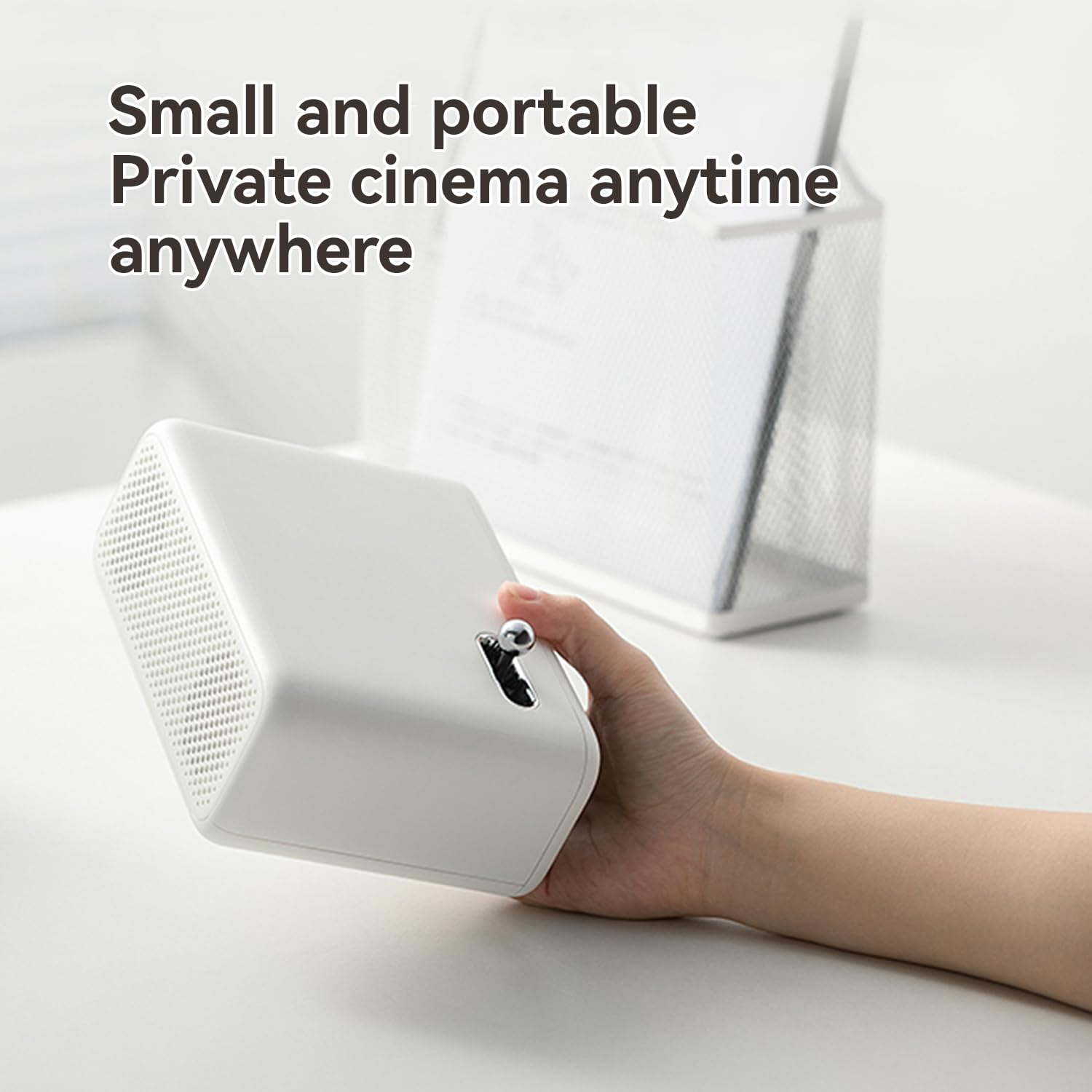 Hand holding white Wanbo Mini Pro smart projector small and portable for private cinema anytime