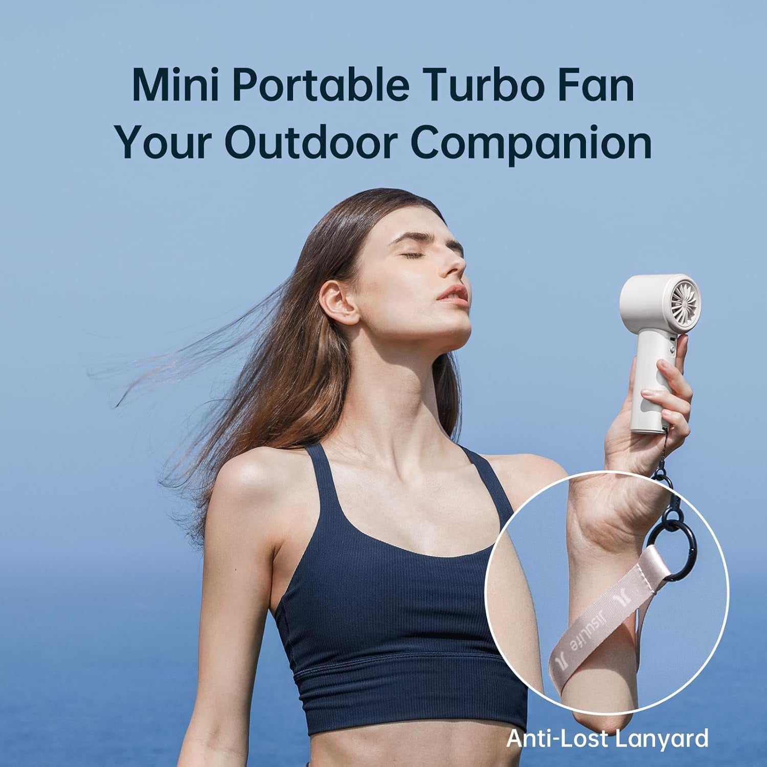 Woman using portable mini handheld fan with anti-lost lanyard outdoors on clear day
