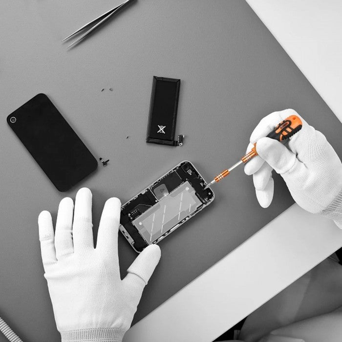 JAKEMY JM-8101 precision screwdriver set being used for smartphone repair with gloved hands
