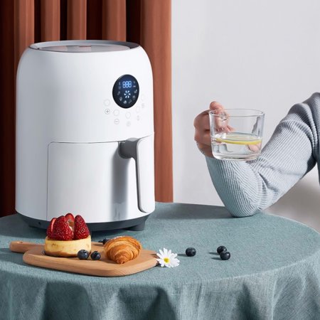 Smart Electric Air Fryer in white with a display, placed on a table with snacks and a glass of water