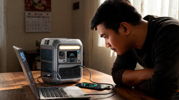 Anker SOLIX C300 portable power station charging a laptop and phone in a Filipino home