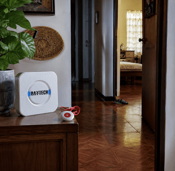 Daytech caregiver pager receiver in a Filipino home hallway, illustrating comparison with monitored medical alert systems