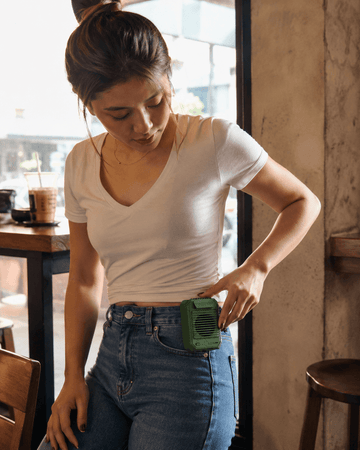 Filipina wearing a 3Life 3-in-1 clip fan at the waist in a Manila cafe