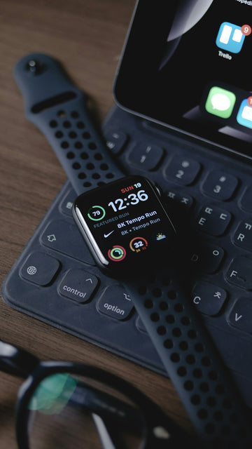 black smart watch on black computer keyboard
