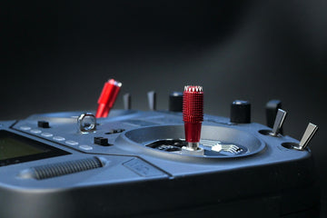 a close up of a device with a red handle