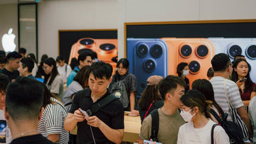 Crowd of people in a busy electronics store.
