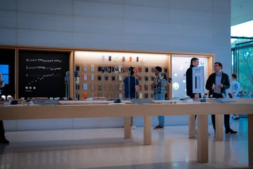 People browsing electronics in a modern store.