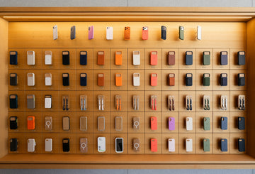 Colorful electronic devices displayed on a wooden shelf