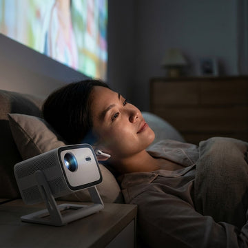 Watching a late-night movie quietly with Bluetooth earbuds and a Wanbo Vali 1 projector