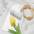 Acrylic Mirror Props displayed with a yellow tulip, jewelry, and decorative items on a soft surface