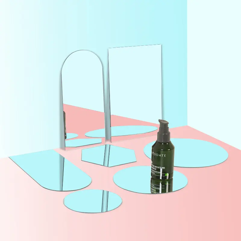 Acrylic Mirror Props in various shapes, reflecting a statue and green foliage for modern decor