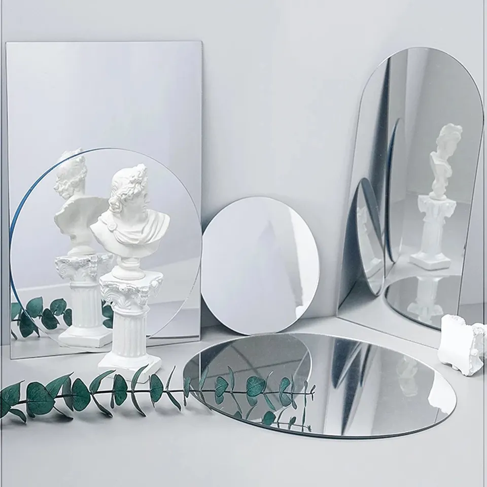 Acrylic Mirror Props in various shapes, reflecting a statue and green foliage for modern decor