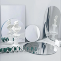 Acrylic Mirror Props in various shapes, reflecting a statue and green foliage for modern decor