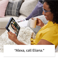 Woman using HD Tablet to video chat while relaxing on a couch with a warm drink