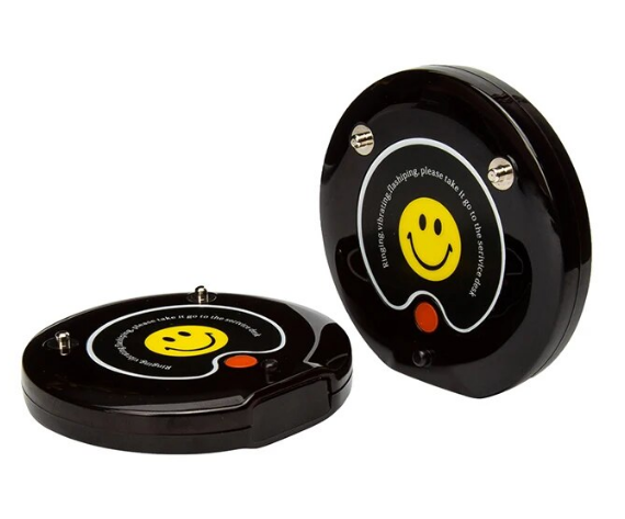 restaurant guest pager system featuring two black beepers with yellow smiley faces best beeper system for restaurants