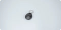 Black teardrop shaped Daytech RFID Tag Card with metal keyring on light gray background