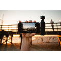 VMIDirect handheld AI Gimbal Camera capturing stunning beach sunset footage with stable support