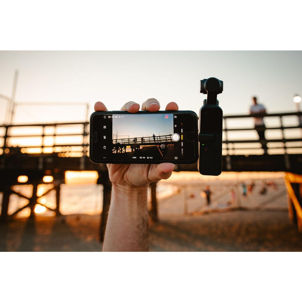 VMIDirect handheld AI Gimbal Camera capturing stunning beach sunset footage with stable support