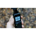 Close-up of VMIDirect handheld AI Gimbal Camera with user interface displayed on the screen