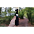 VMIDirect handheld AI Gimbal Camera held in hand with forest background for stable video capture