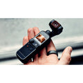 VMIDirect handheld AI Gimbal Camera in a person's hand with touchscreen display and compact design