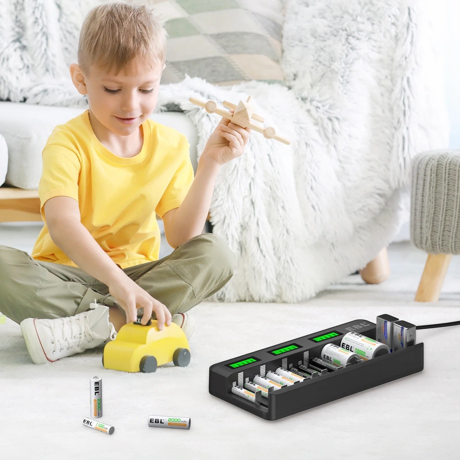 12 bay LCD battery charger by VMIDirect charging multiple AA and AAA batteries beside a child playing with wooden toys