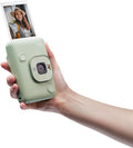 FUJIFILM INSTAX Mini LiPlay in green held in hand with instant photo printing feature