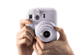 Fujifilm Instax Mini 12 Camera in Lavender Color with User Holding it Ready to Capture Moments
