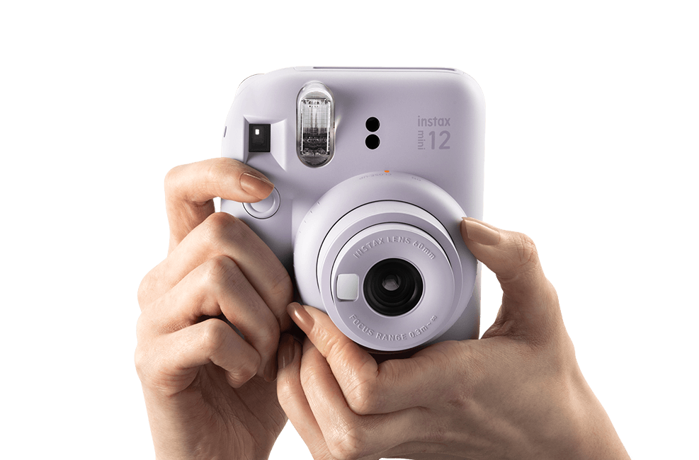Fujifilm Instax Mini 12 Camera in Lavender Color with User Holding it Ready to Capture Moments
