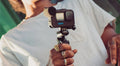 Man holding a GoPro camera with the GoPro Media Mod attachment for enhanced audio and video quality
