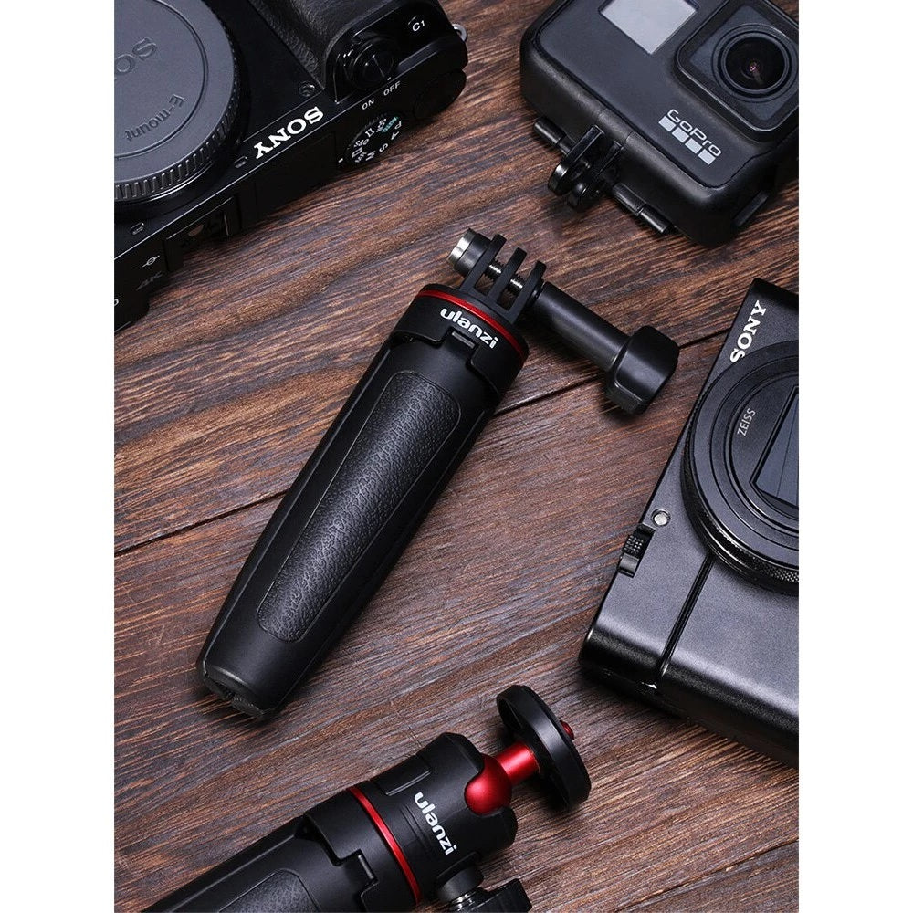 GXCT MT-09 Mini 2-in-1 Vlog Tripod on a wooden surface surrounded by cameras