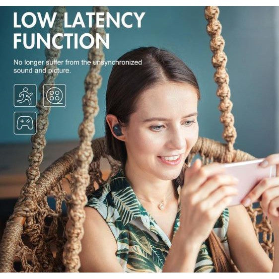 Woman using wireless earbuds while playing a mobile game in a cozy hanging chair