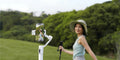 Woman using iSteady V3 Smartphone Gimbal while walking in a scenic outdoor setting