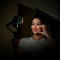 Woman using the iSteady V3 Smartphone Gimbal for smooth video recording in low light conditions