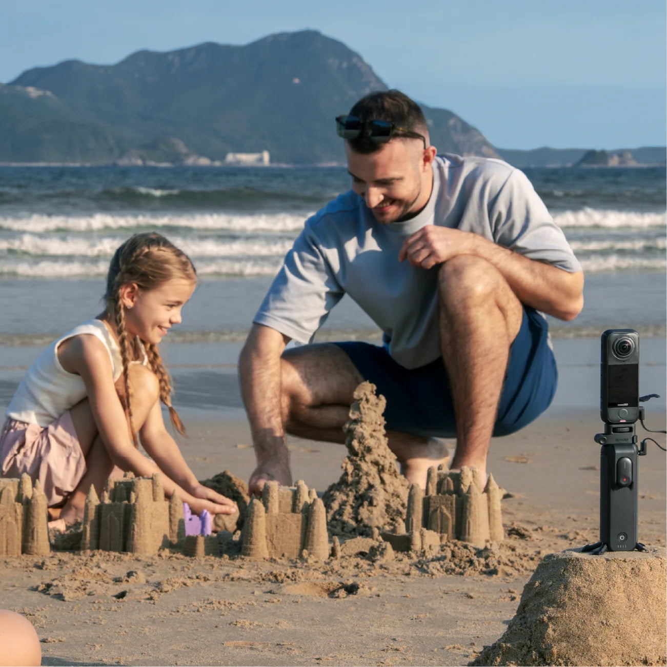 8K Waterproof Action Camera capturing family fun at the beach with kids building sandcastles