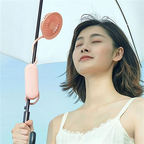 Mini portable fan USB rechargeable attached to umbrella blowing air on woman outdoors