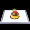 LED light panel for photography featuring a dessert with a strawberry and mint garnish
